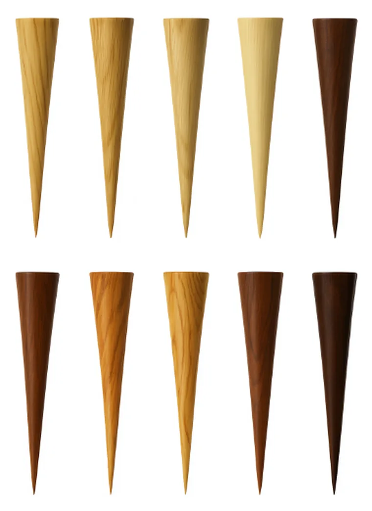 Coming soon concept render of ten wood-grain golf tees, from pale to dark
